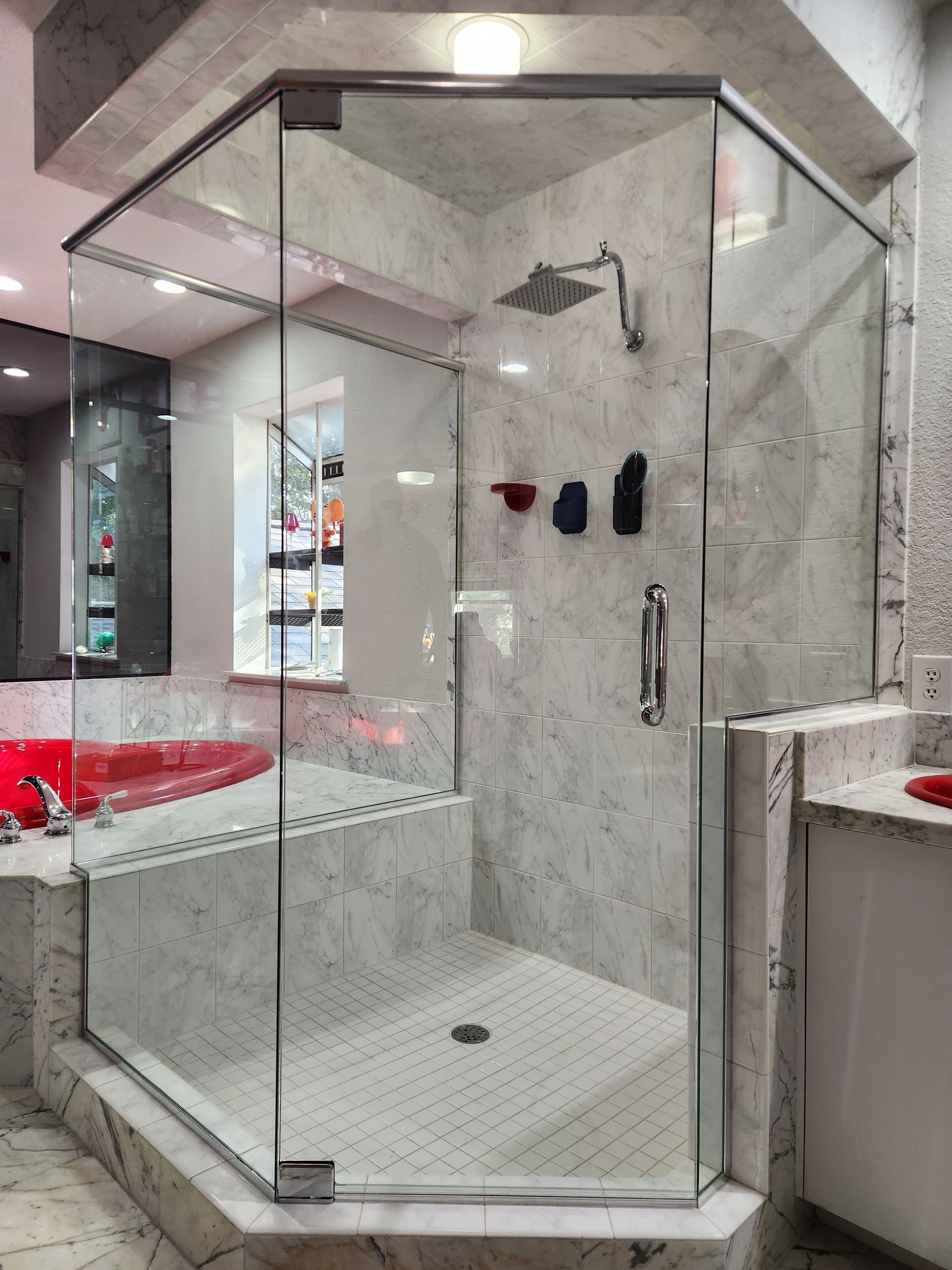 a bathroom with a walk-in shower and a bathtub