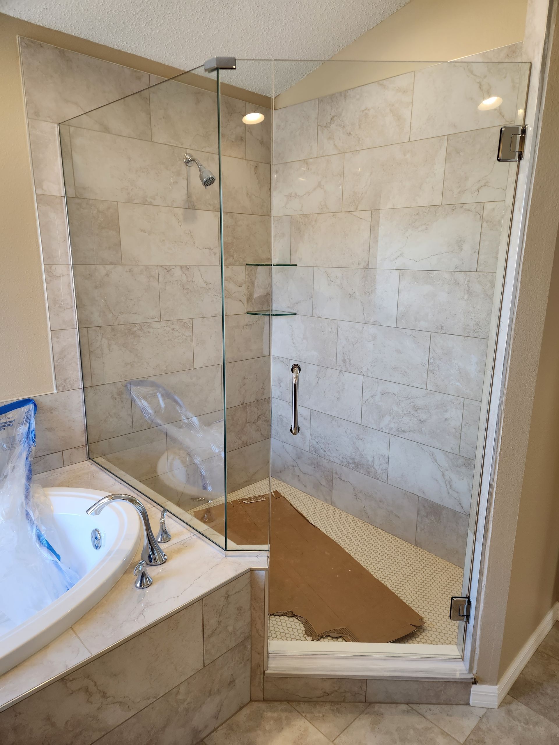 a bathroom with a walk-in shower and a bathtub