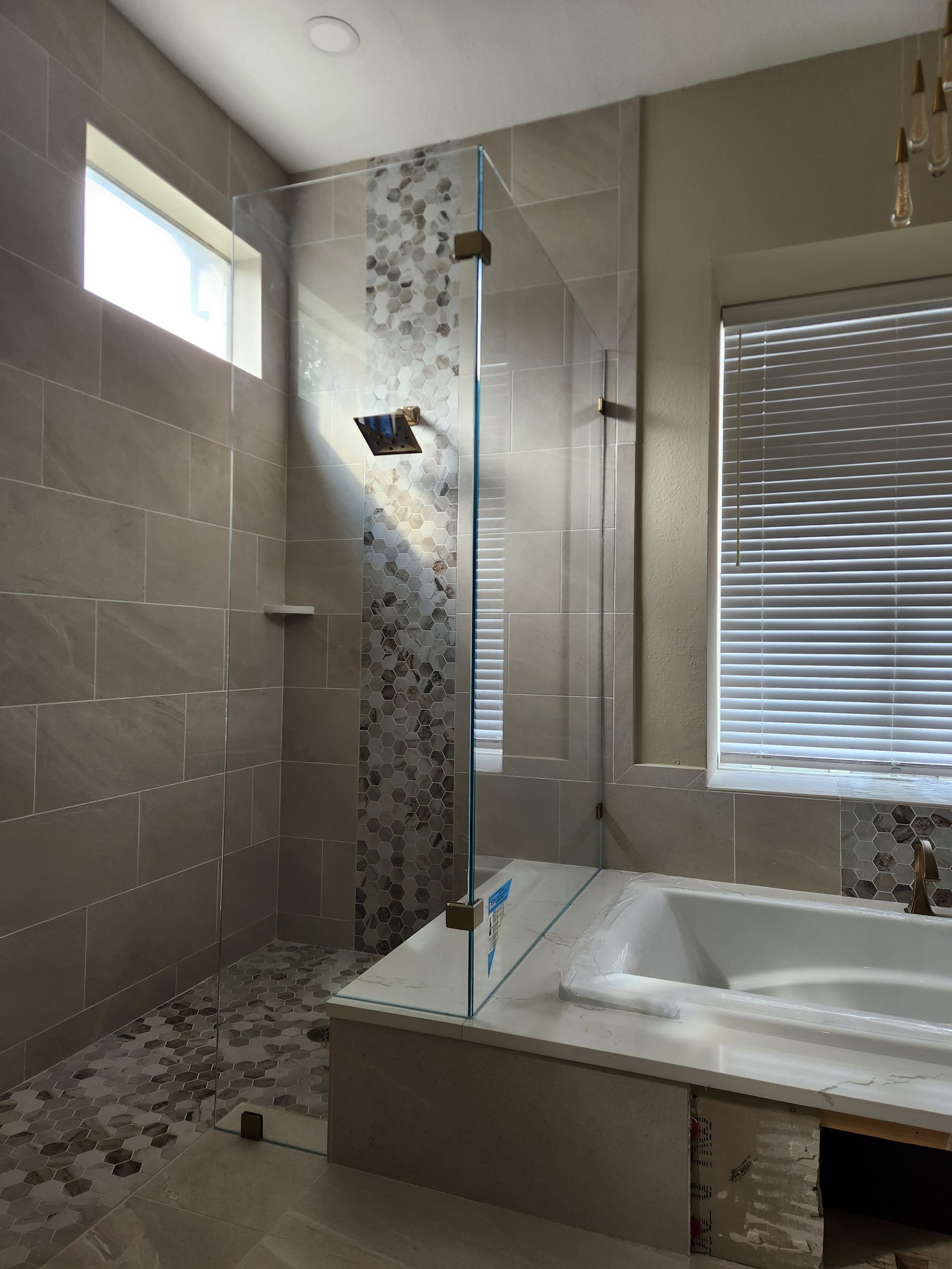 a bathroom with a walk-in shower and a bathtub