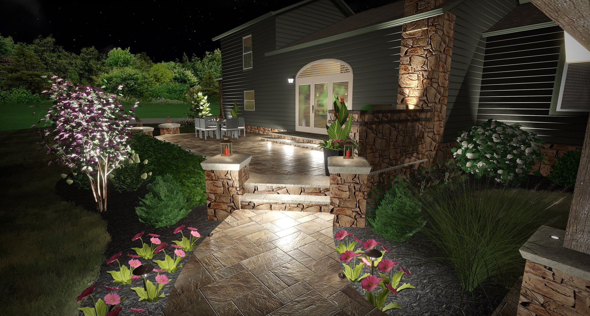 Lit garden walkway with flower beds, stone steps, and illuminated brick house entrance at night