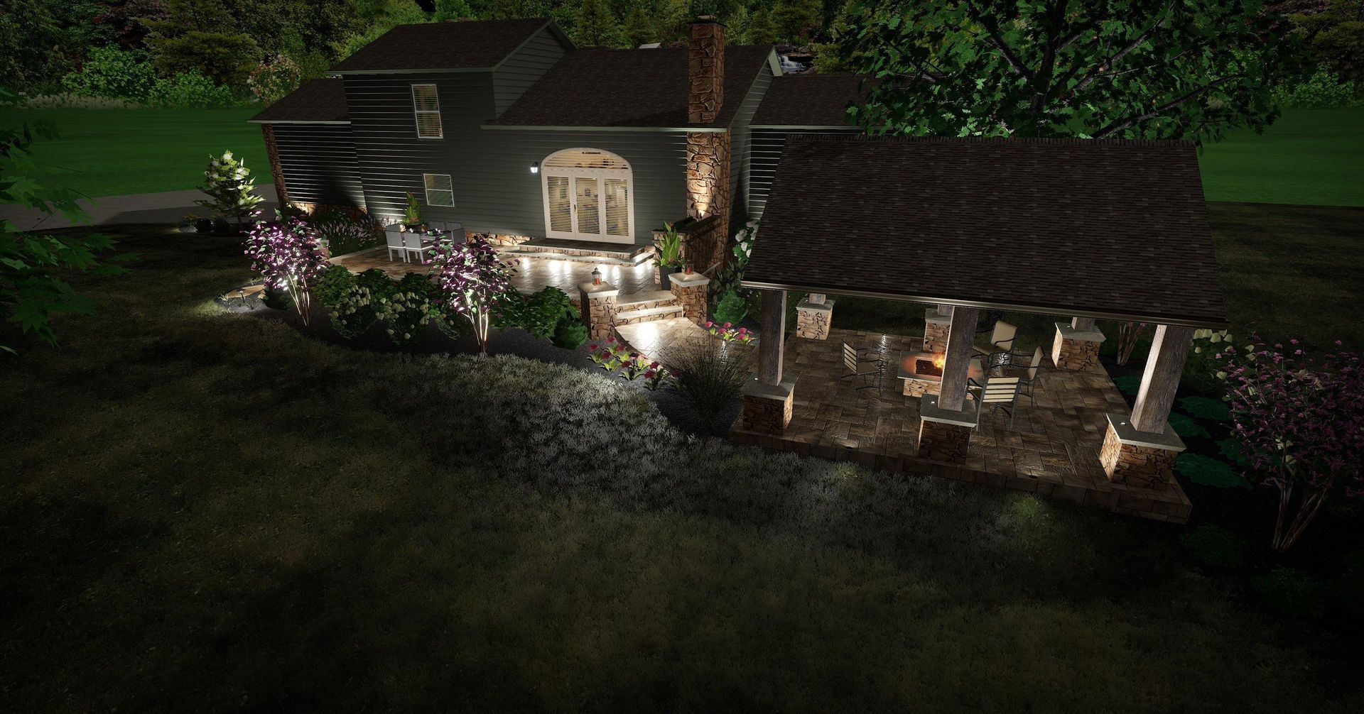 House with lit porch and garden path at night, surrounded by trees and greenery