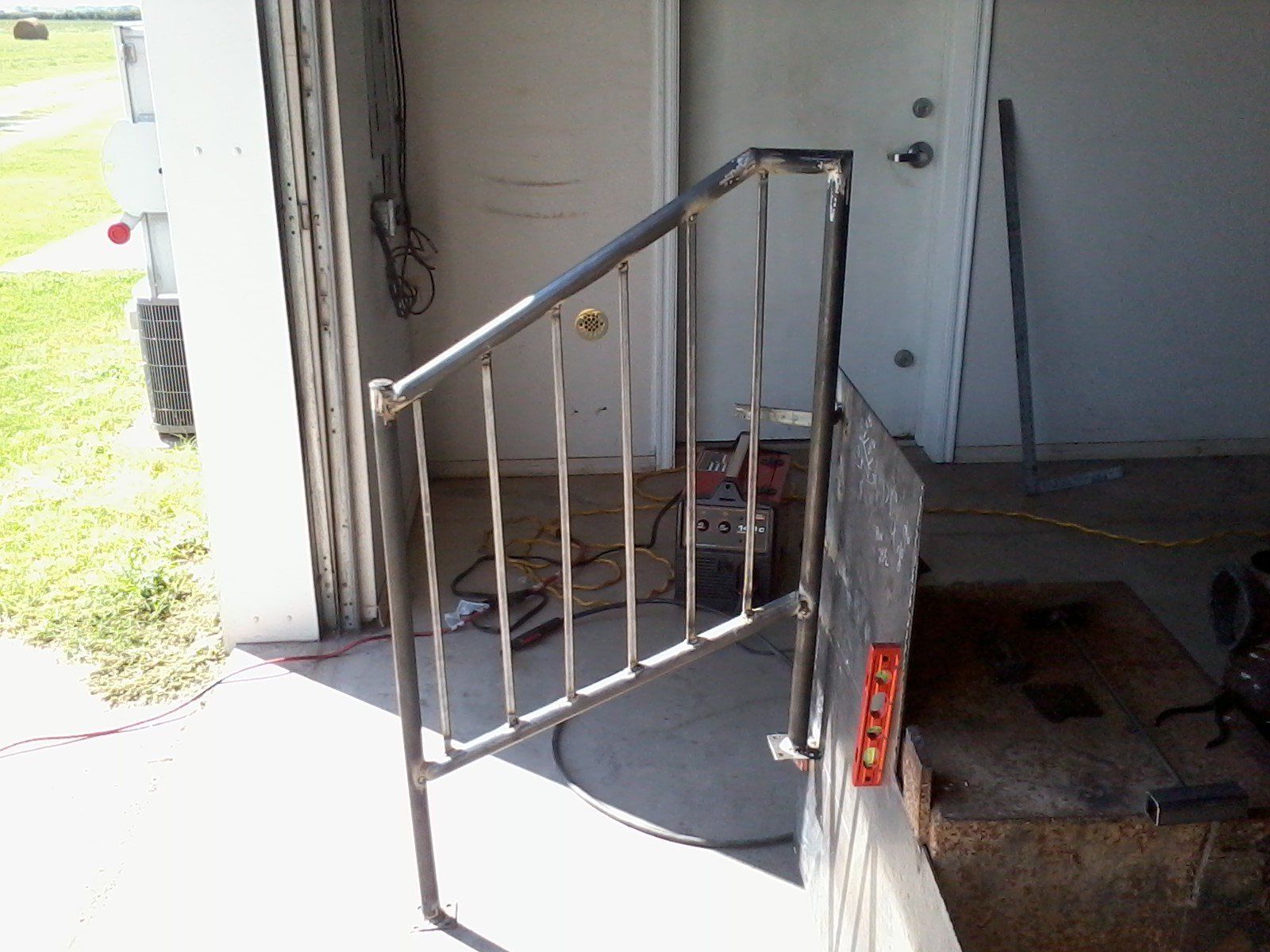 A metal railing is being built in a garage