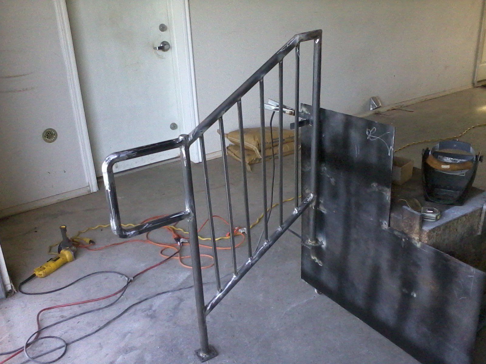 A metal railing is being built in a room.