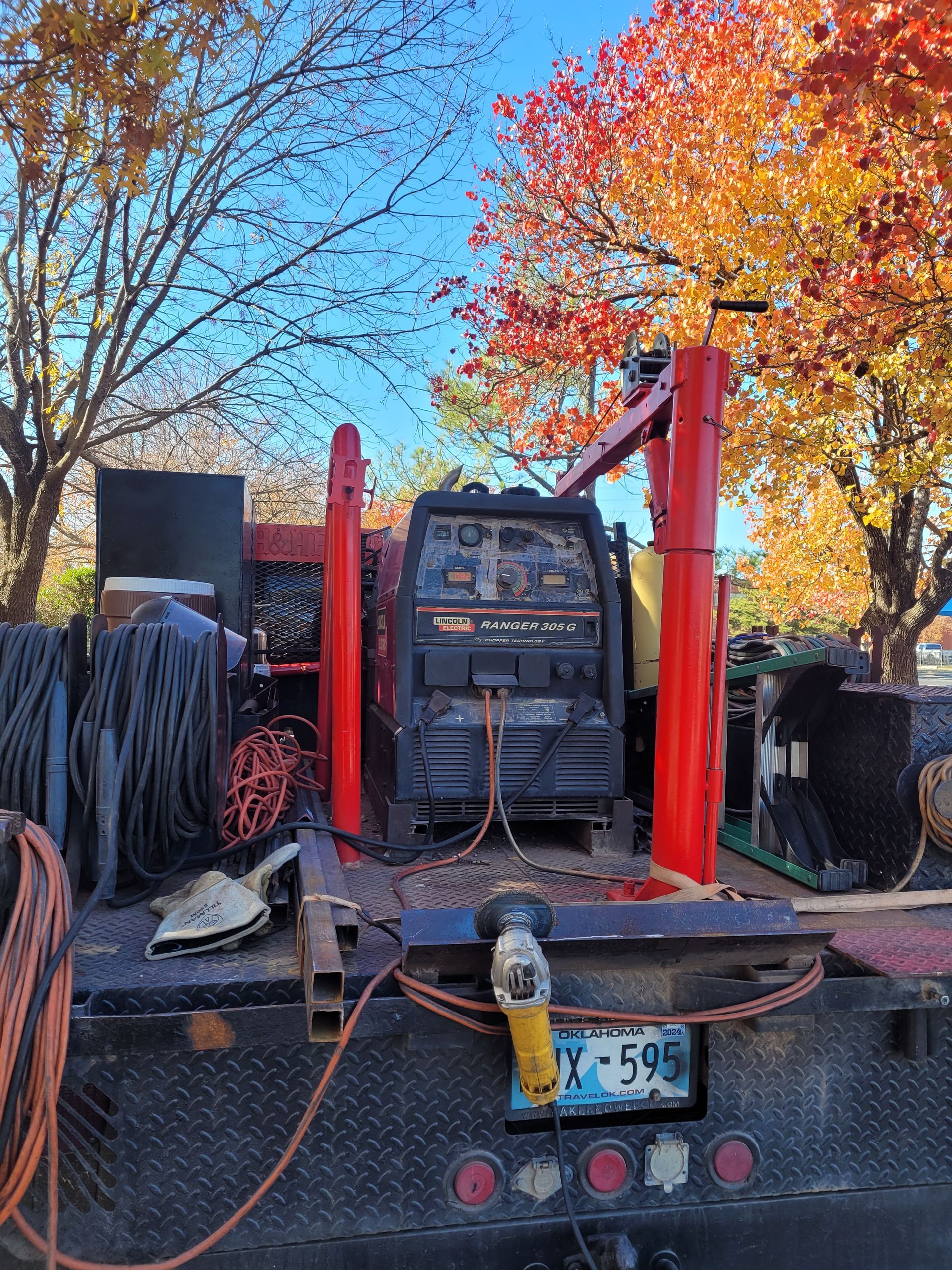 A welding machine is sitting on the back of a truck.