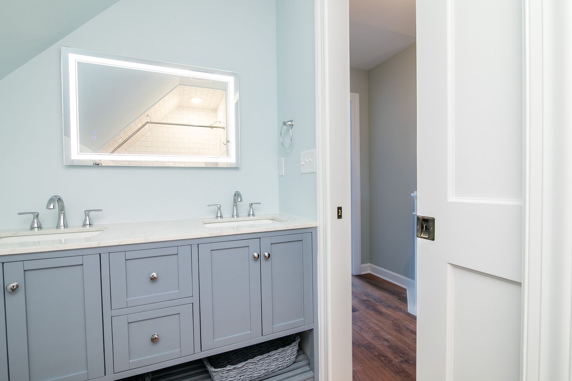 A bathroom with two sinks and a large mirror.