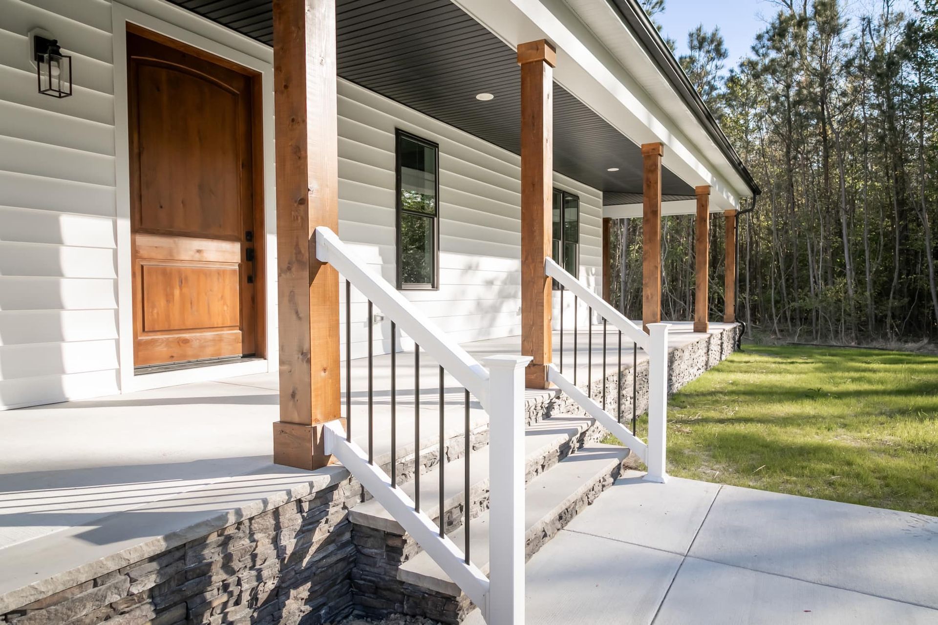 A white house with a porch and a wooden door.