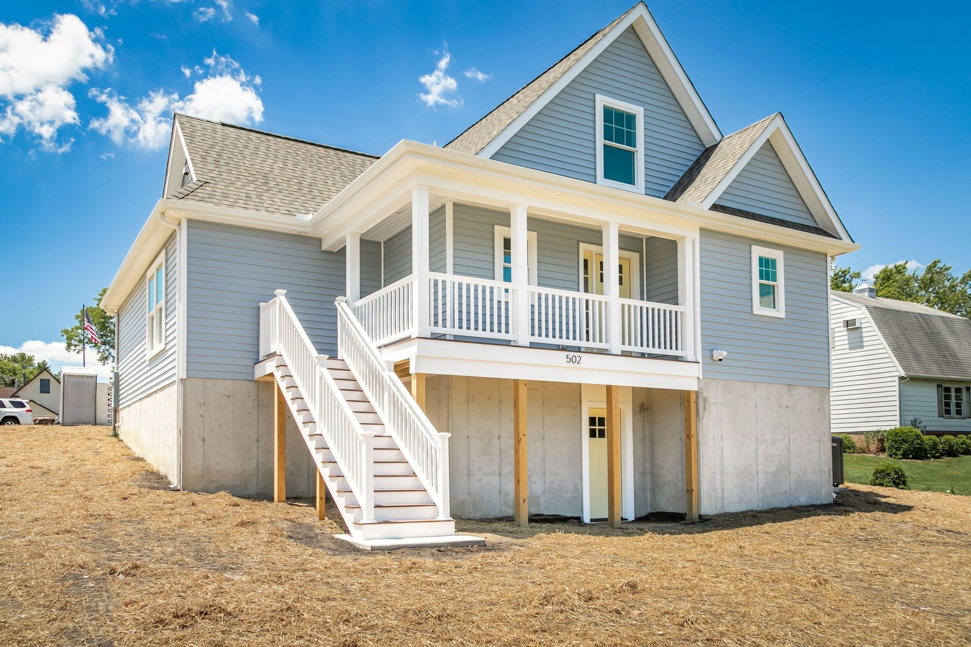 A large house with a large porch and stairs