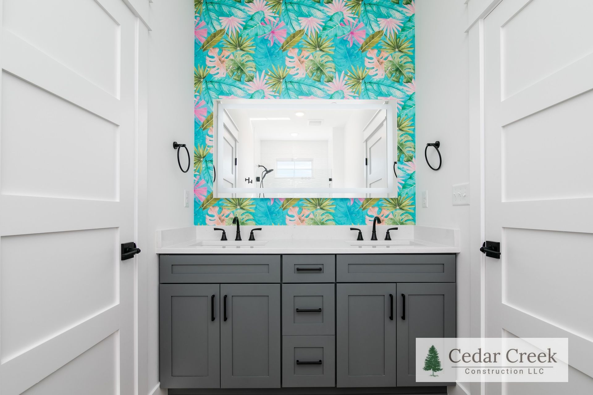 A bathroom with two sinks and a mirror