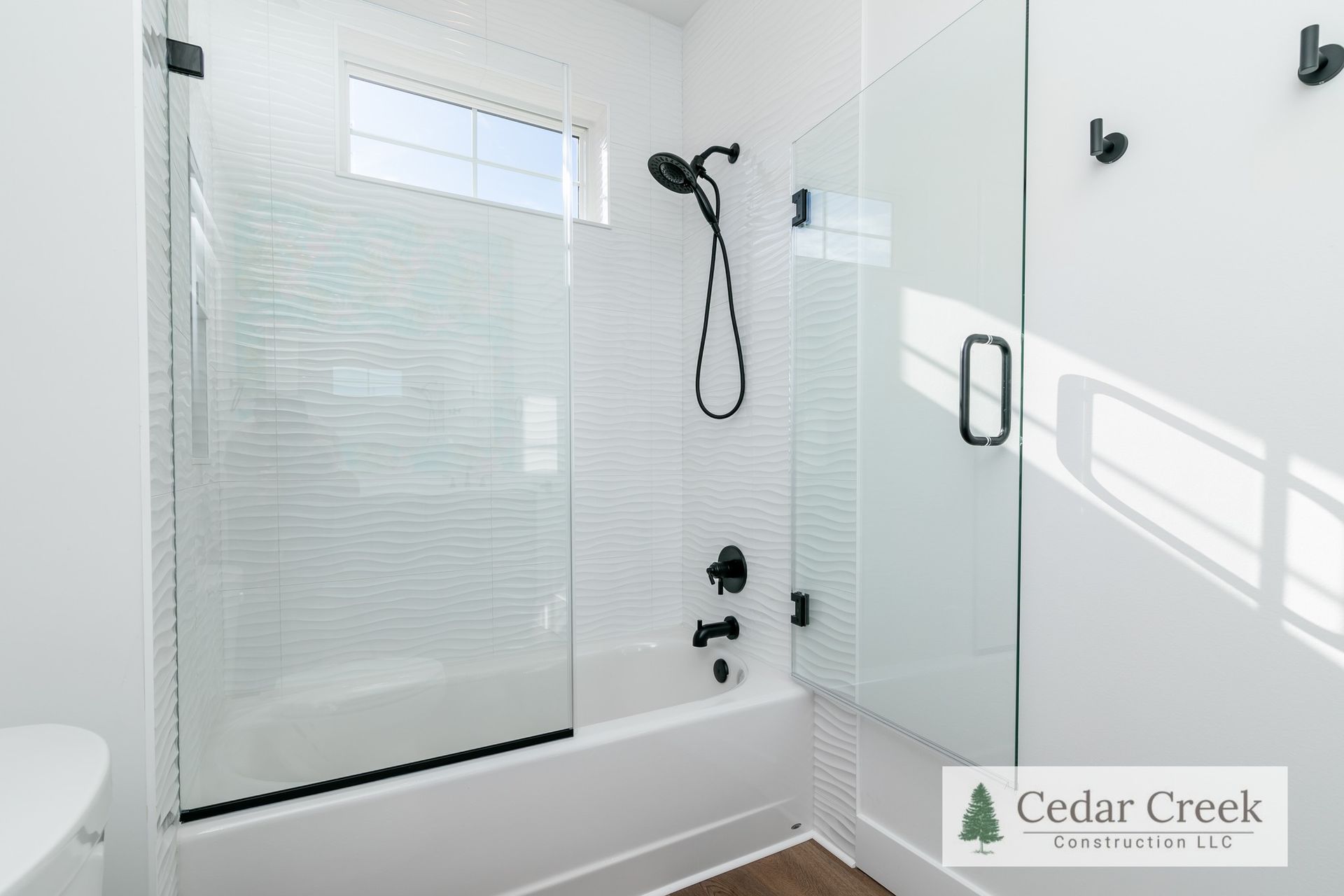 A bathroom with a walk in shower and a bathtub