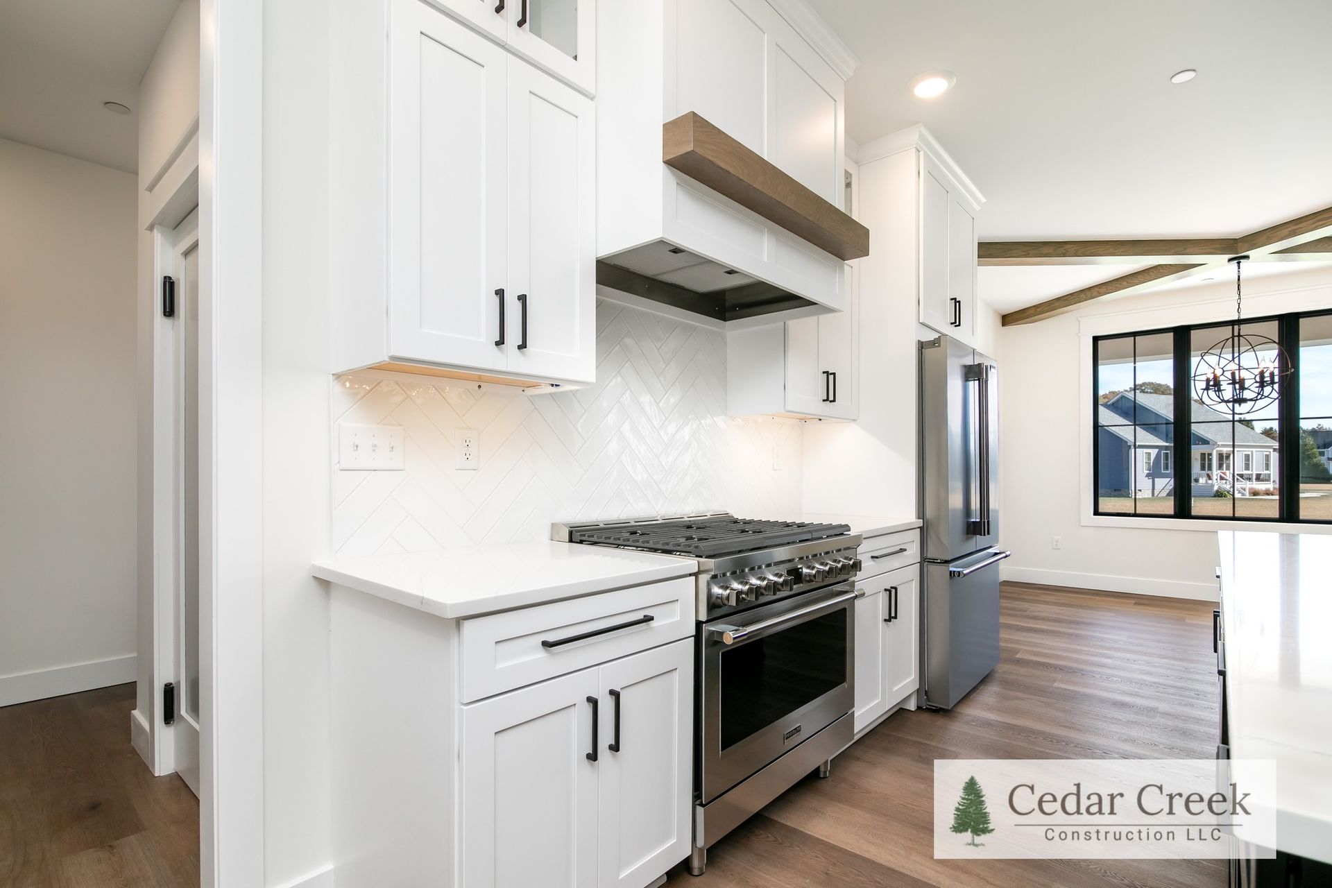 A kitchen with white cabinets and stainless steel appliances