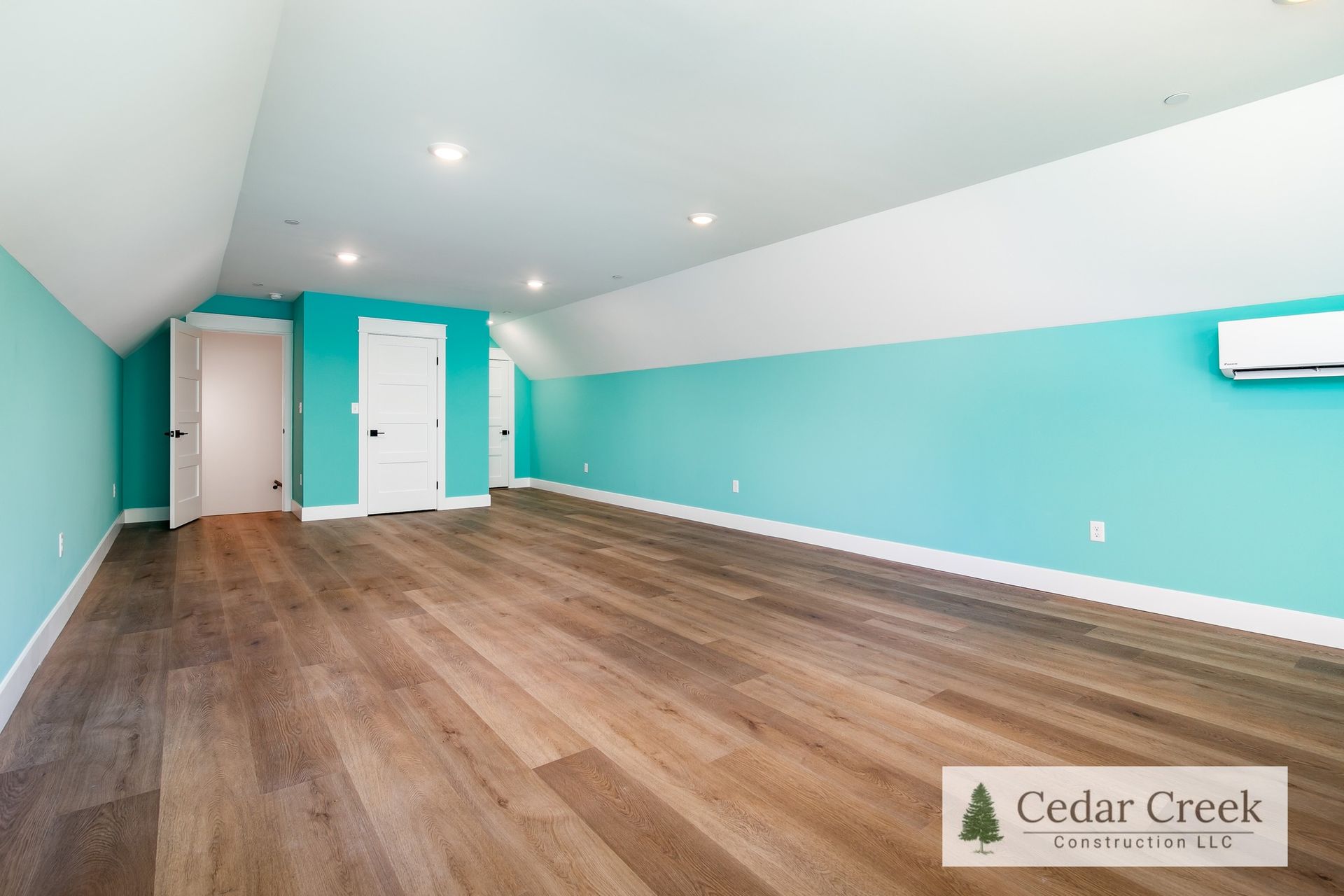 An empty room with hardwood floors and blue walls