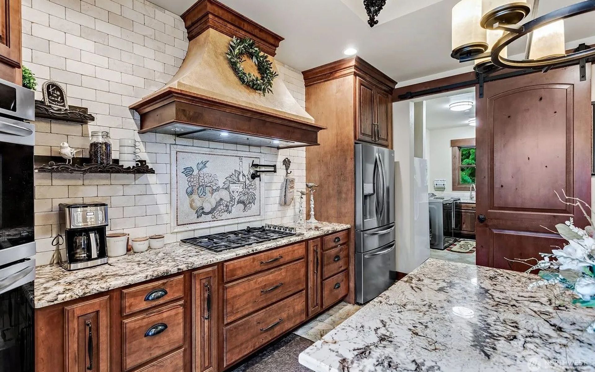 A kitchen with black cabinets and stainless steel appliances