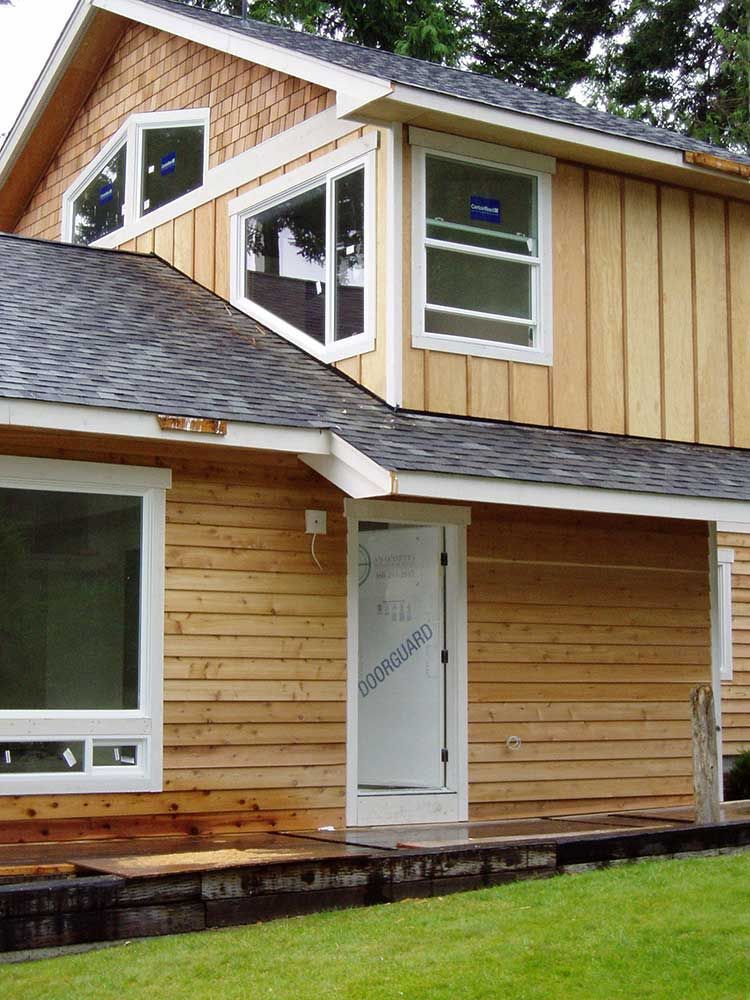 A house with a lot of windows and a roof