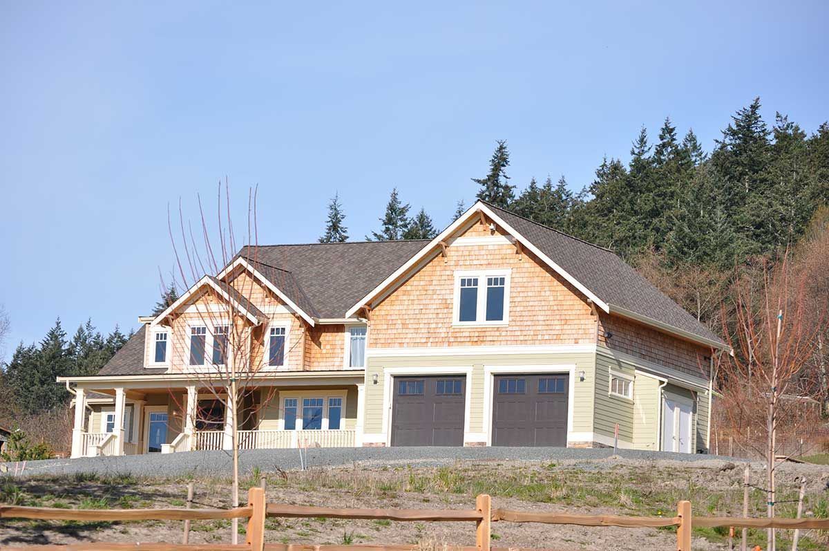 A large house with a wooden fence in front of it