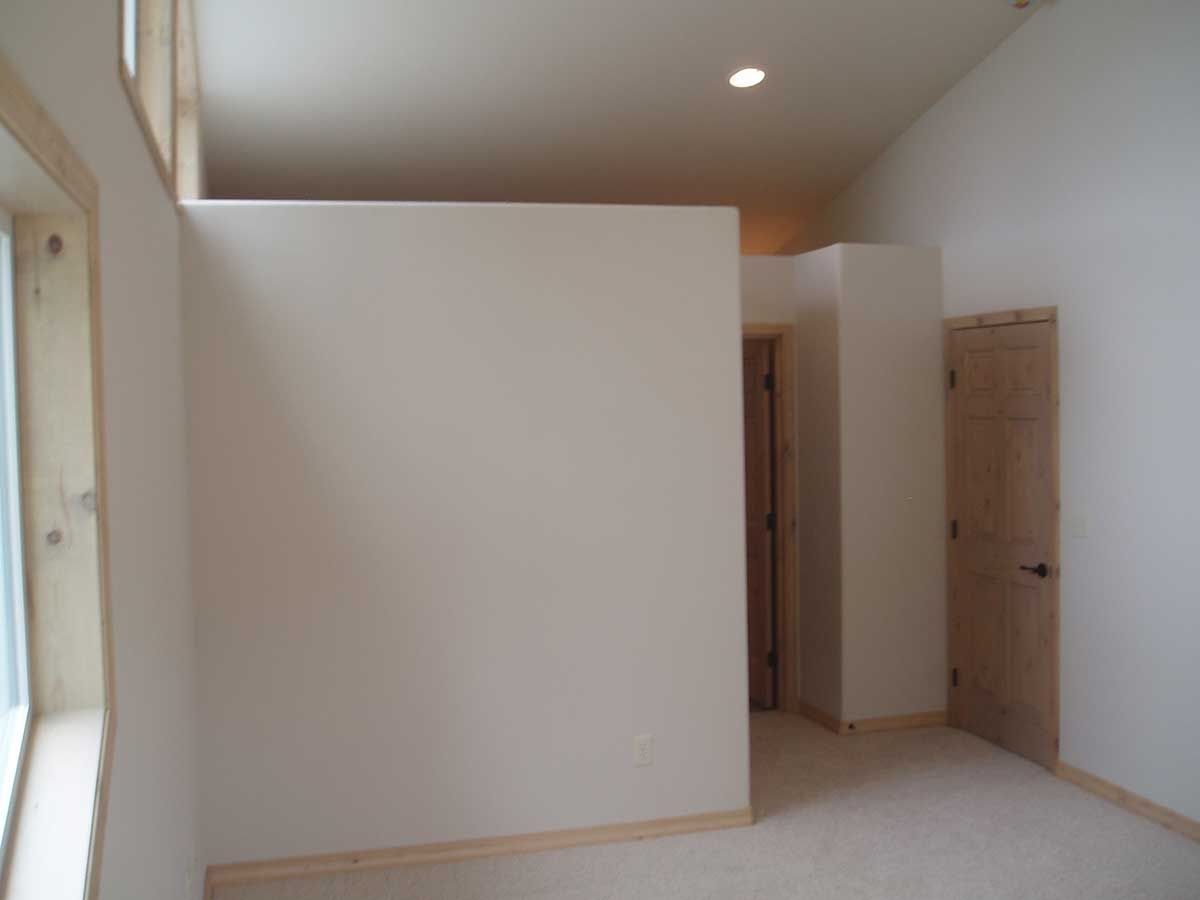 An empty room with white walls and a door