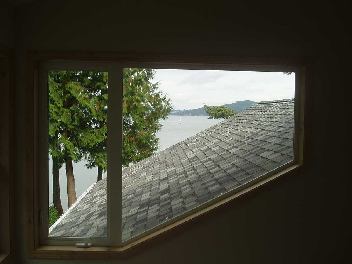 A window with a view of a lake and trees