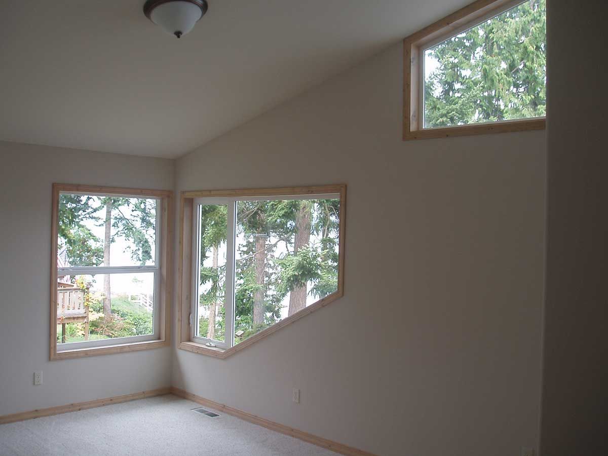A room with a lot of windows and a ceiling light