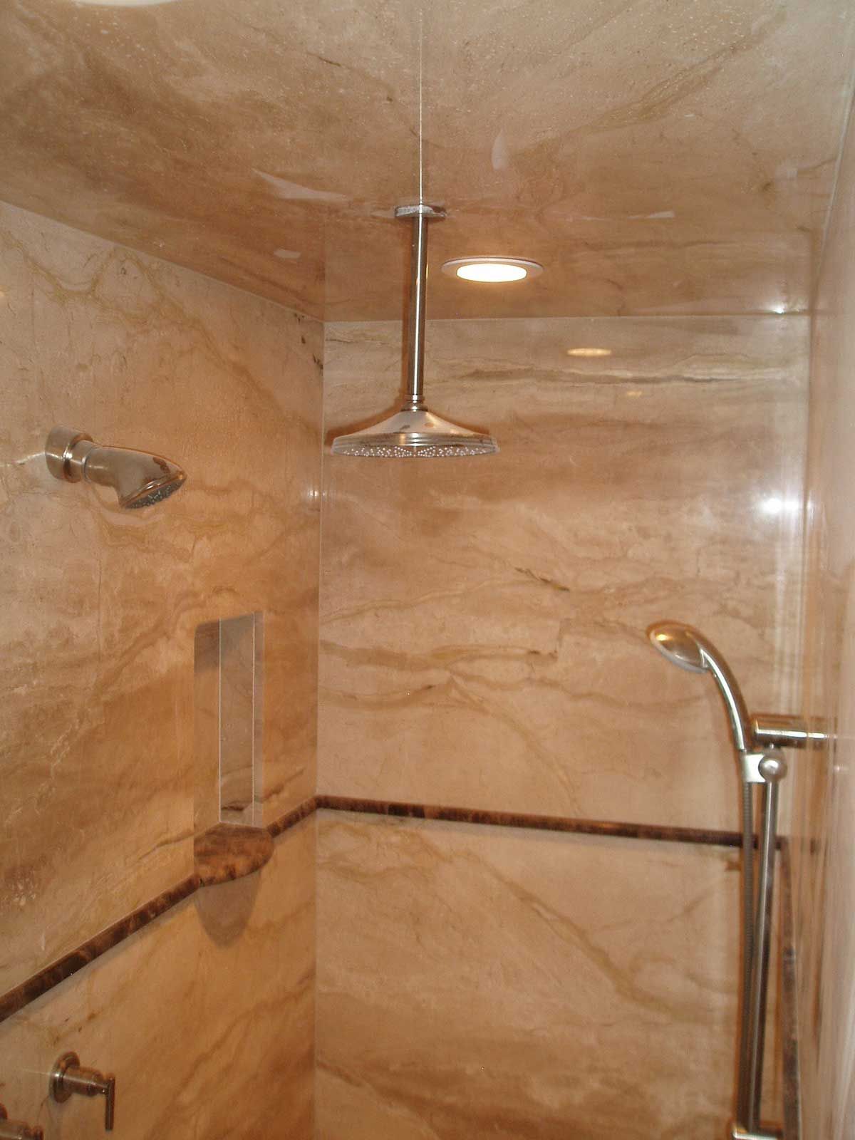 A bathroom with a shower head hanging from the ceiling