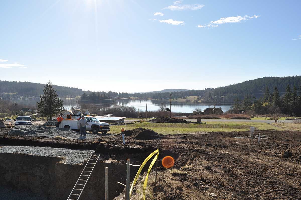 A construction site with a large body of water in the background