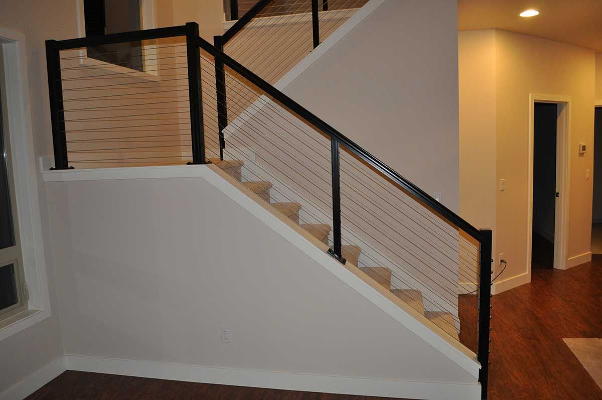 A staircase with a black railing and white steps