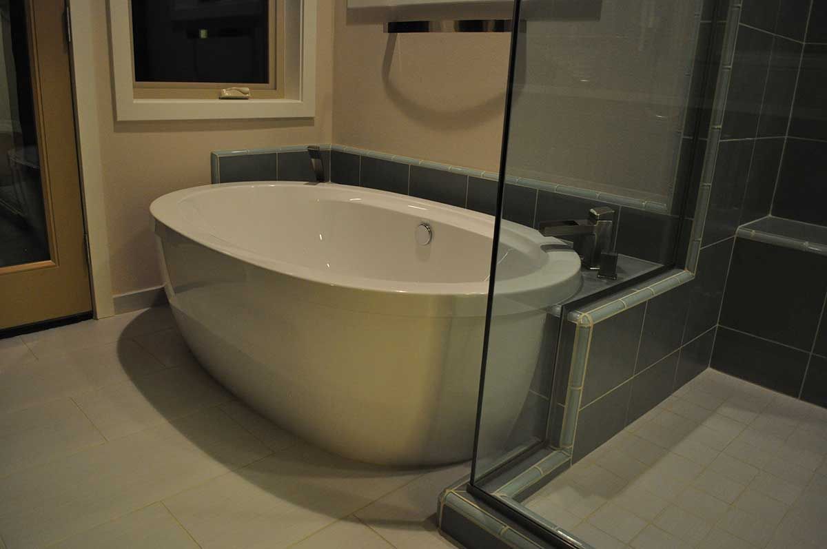 A bathroom with a bathtub and a walk in shower.