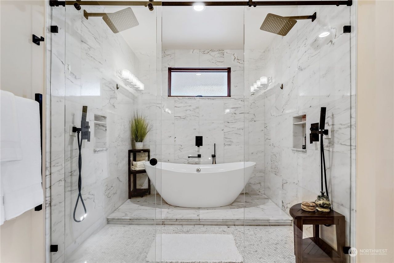 A bathroom with a bathtub and a walk in shower.