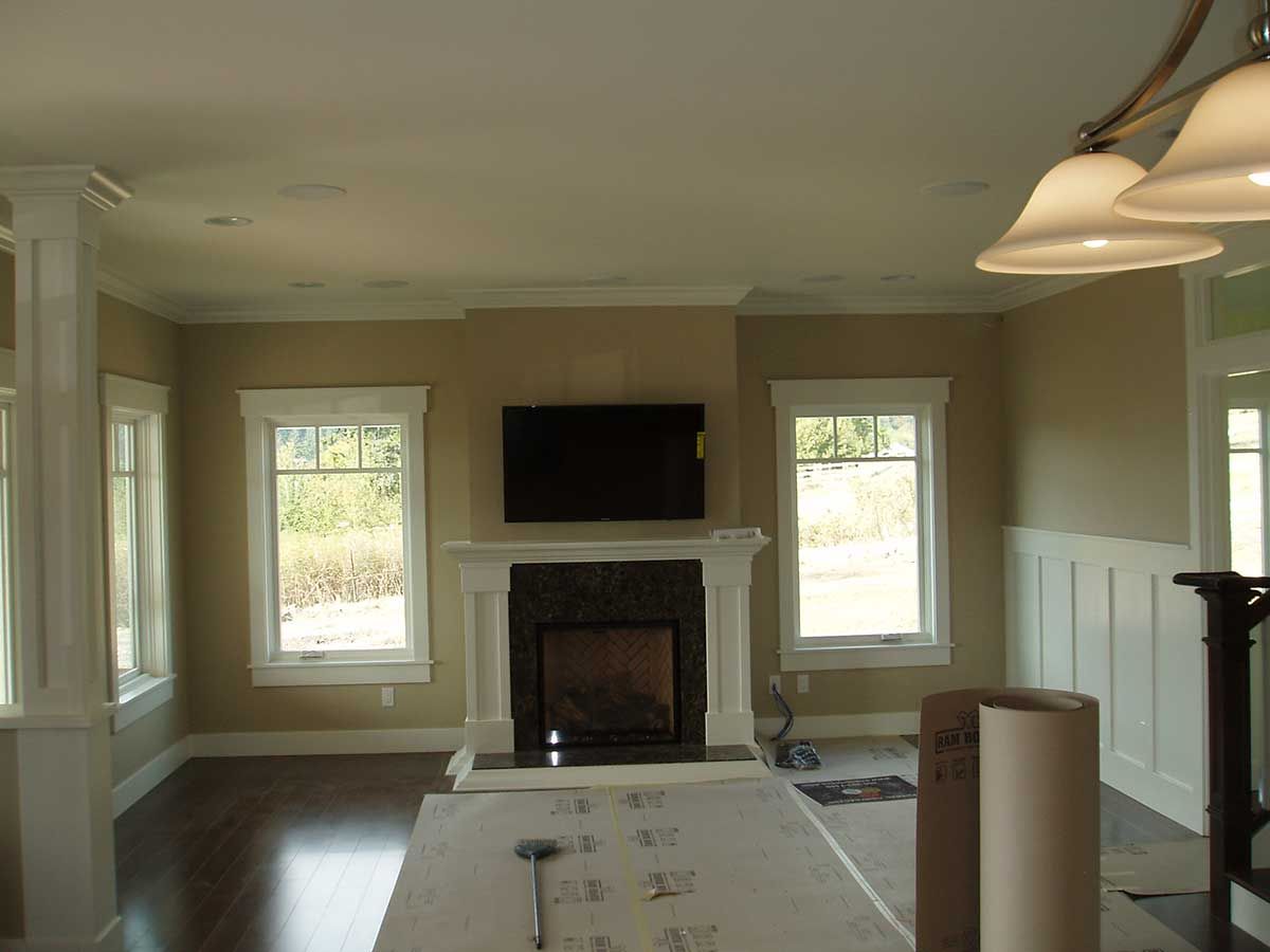 A living room with a fireplace and a flat screen tv