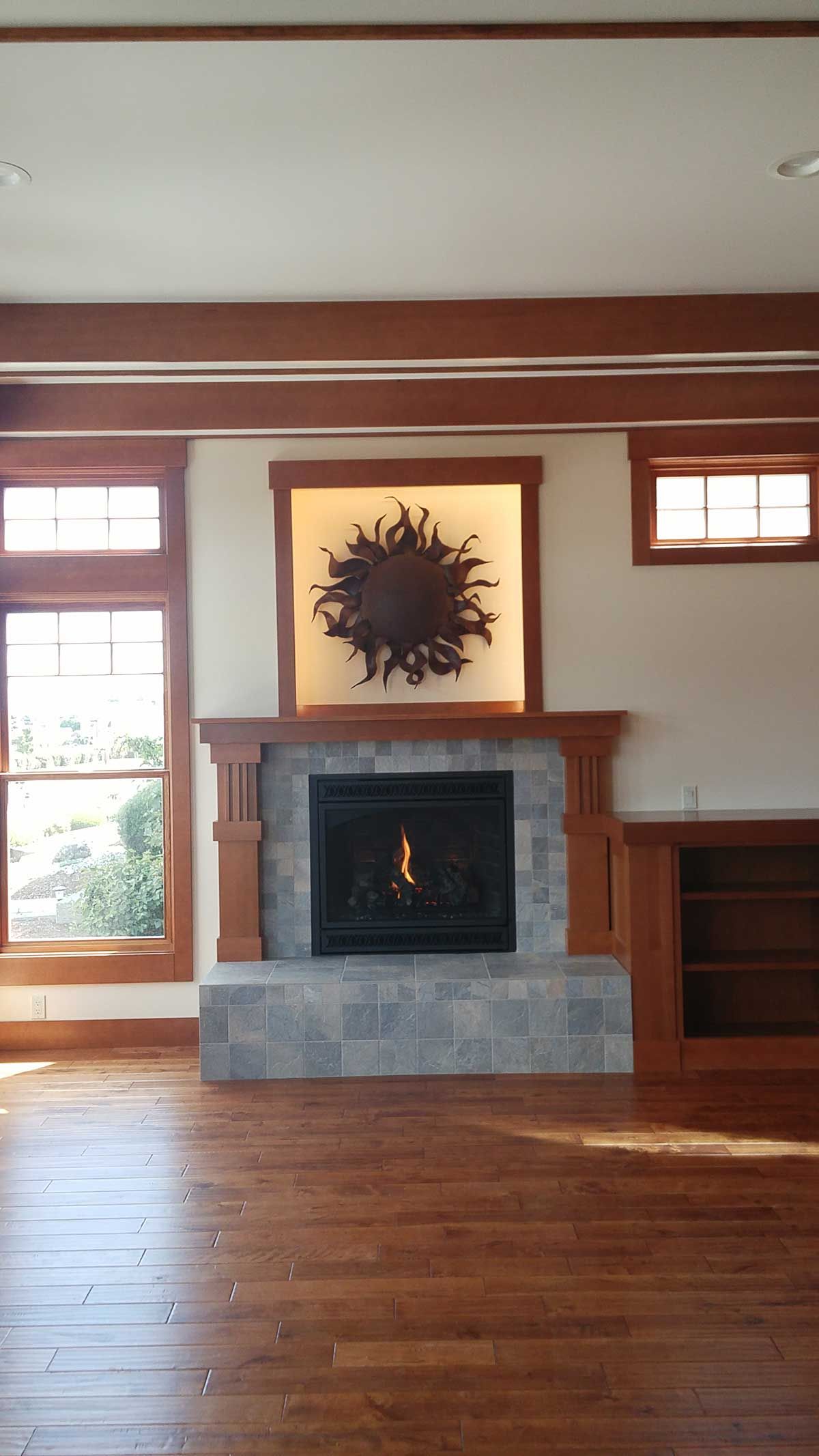 A living room with a fireplace and wooden floors