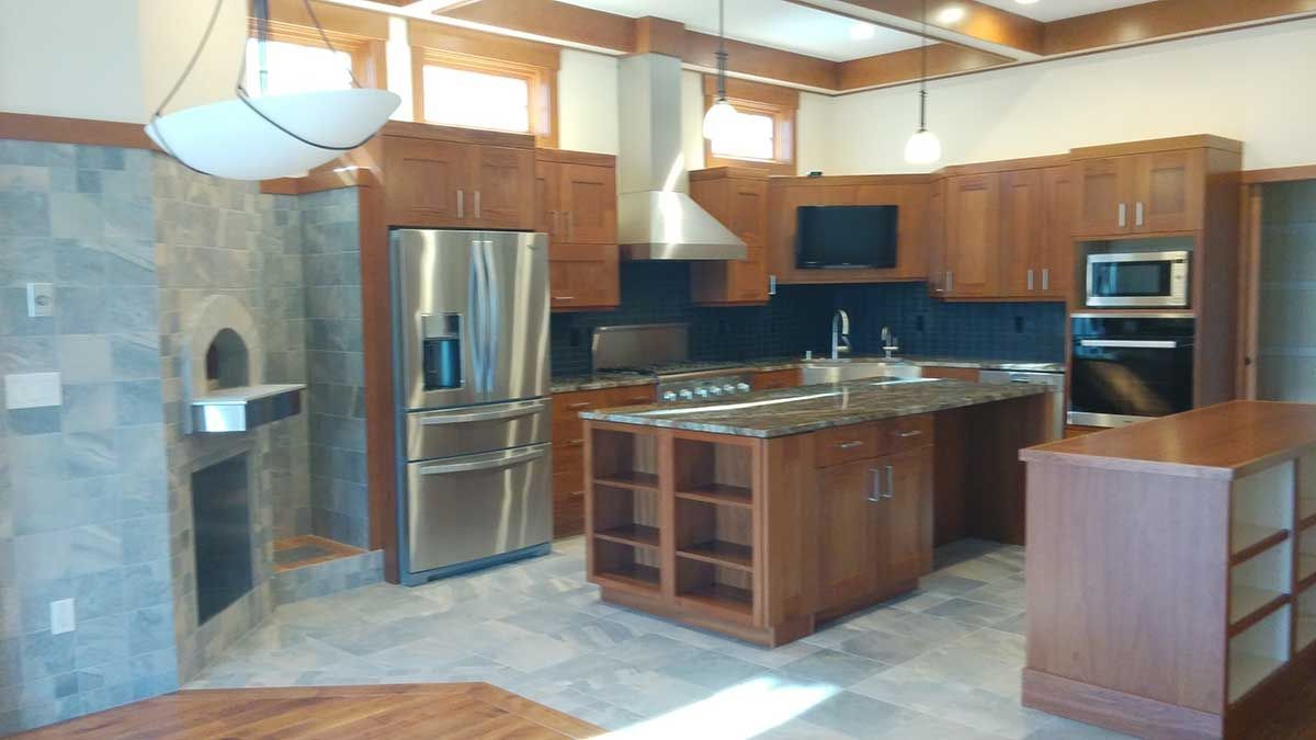A kitchen with stainless steel appliances and wooden cabinets