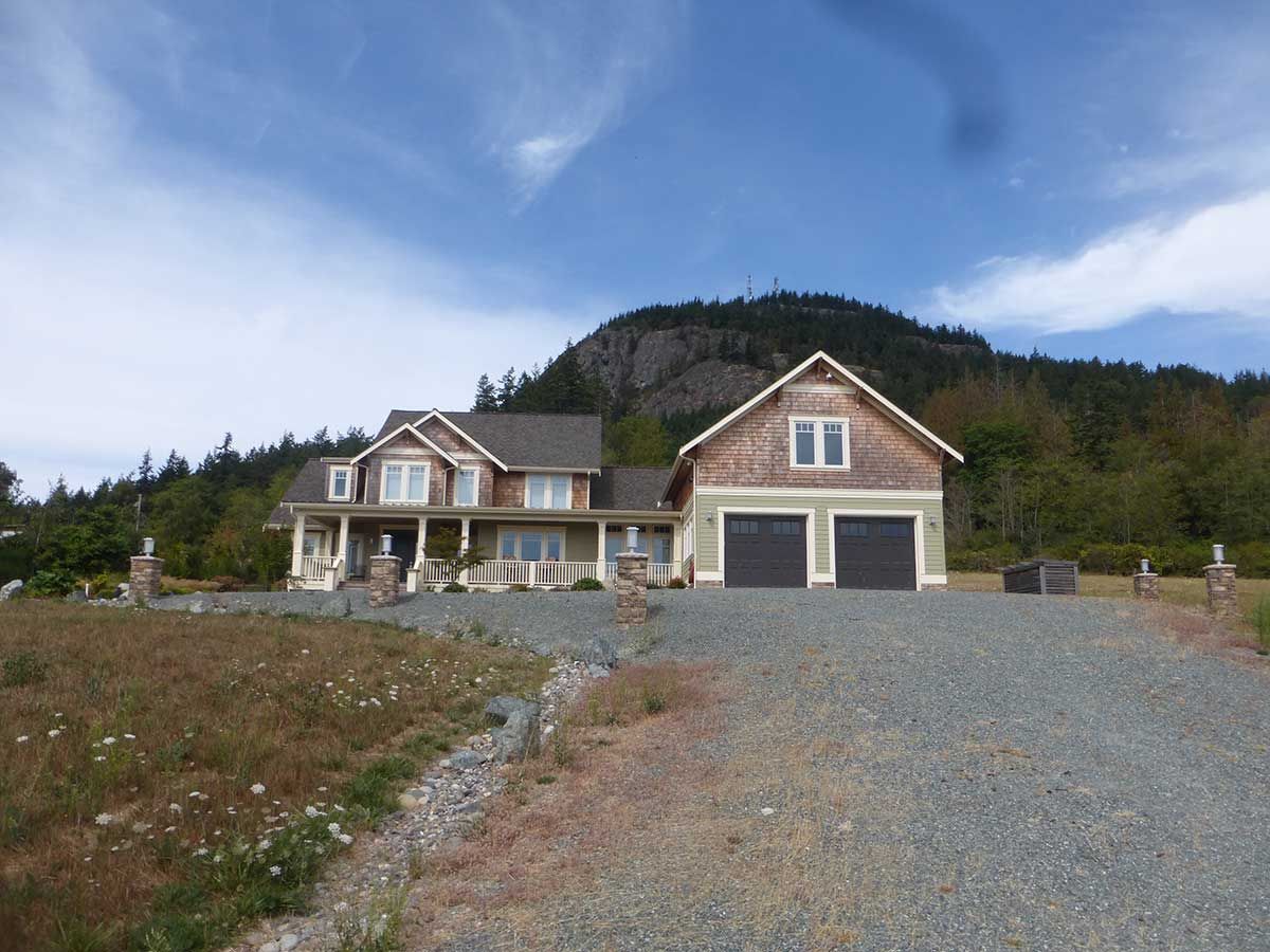 A large house with a mountain in the background