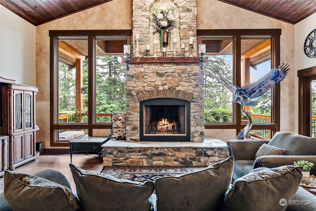 A living room with a fireplace and a lot of windows.