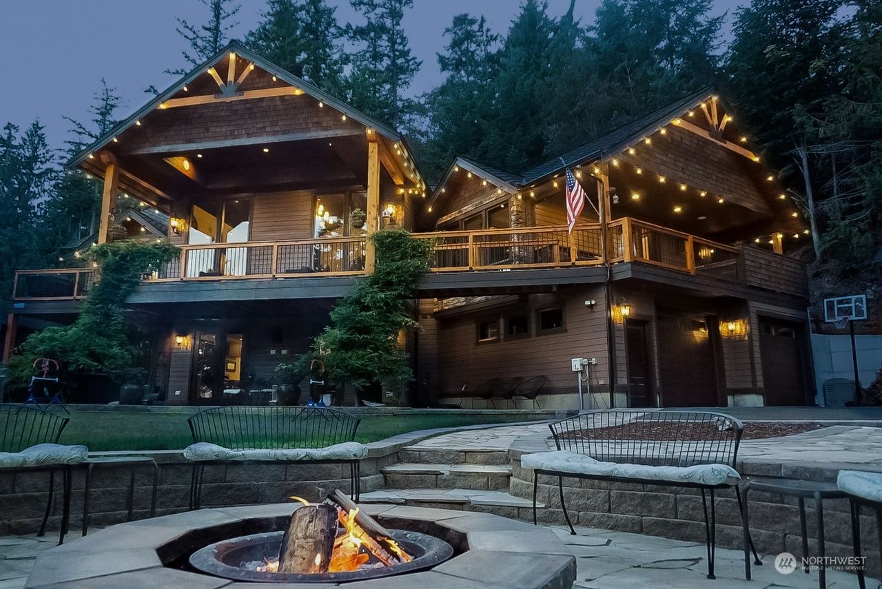 A large house with a fire pit in front of it.