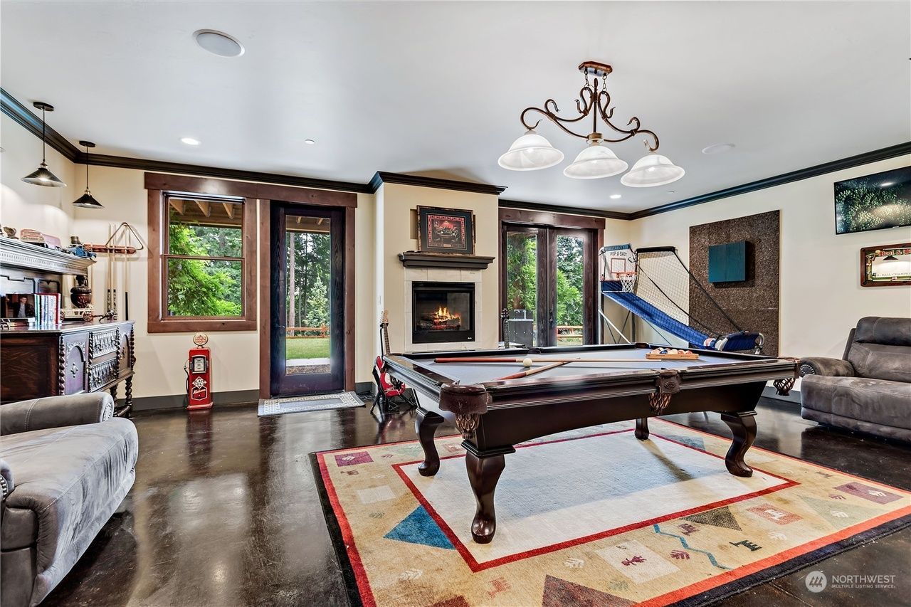 There is a pool table in the middle of the room.