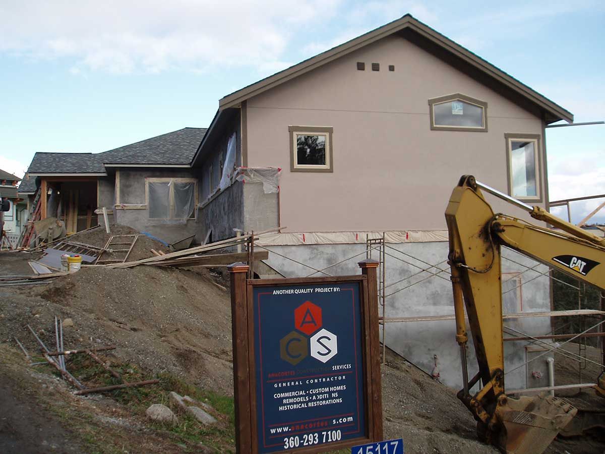 A house that is being built with a sign in front of it