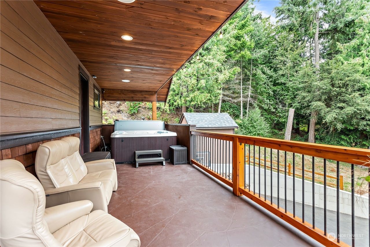 There is a hot tub on the deck of a house.