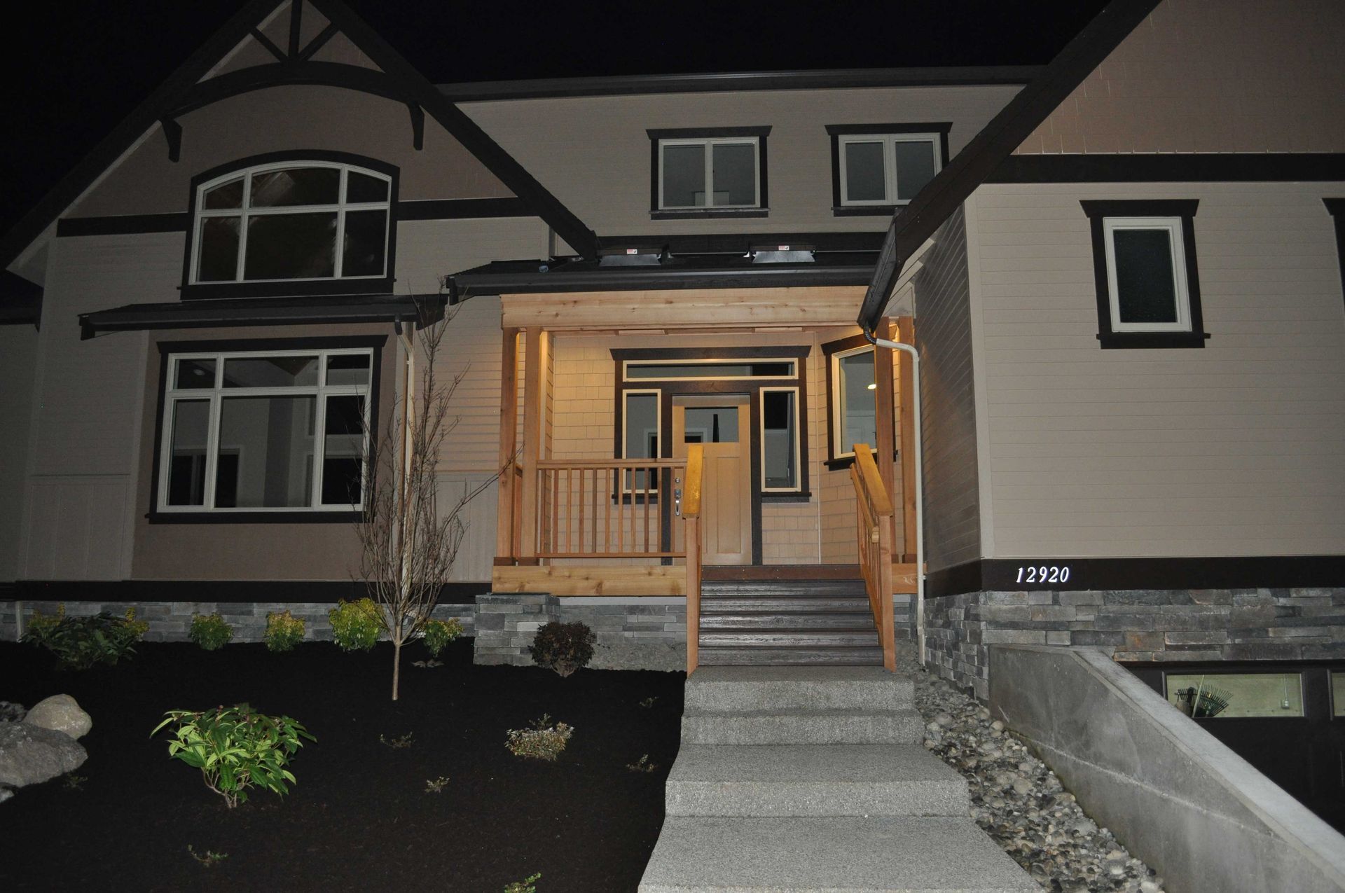 A large house with stairs leading up to the front door