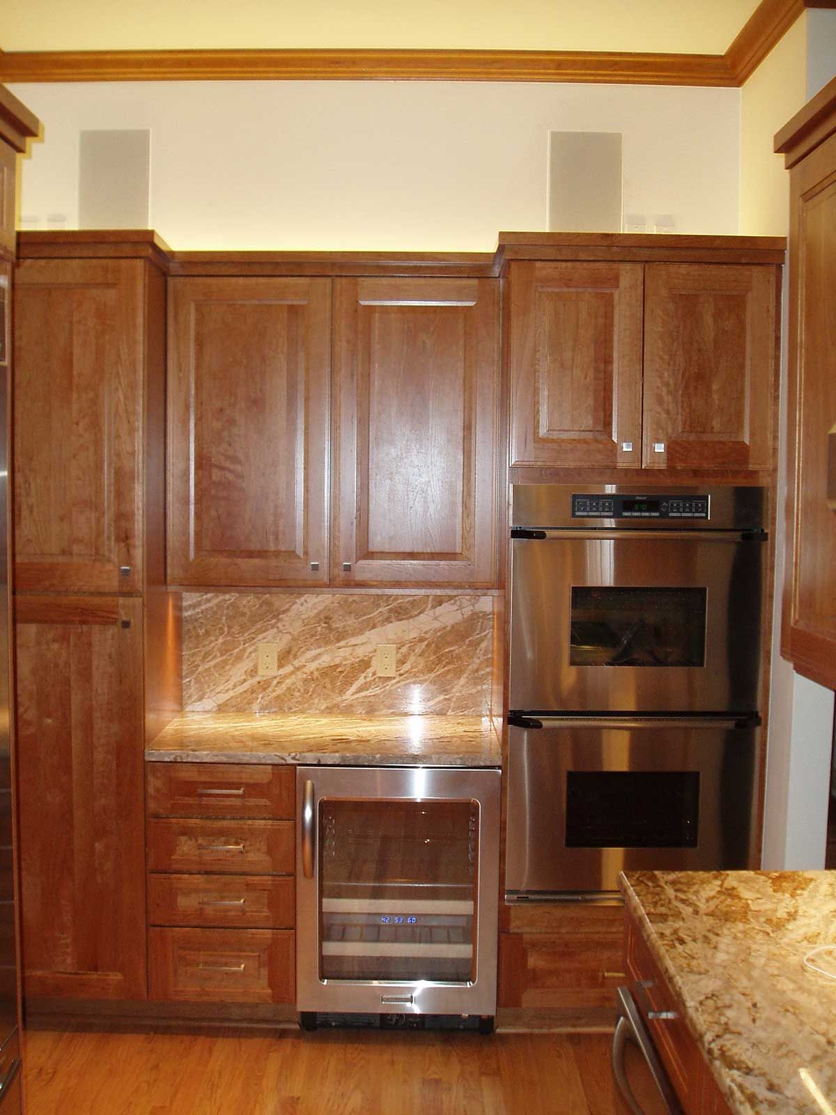 A kitchen with stainless steel appliances and wooden cabinets