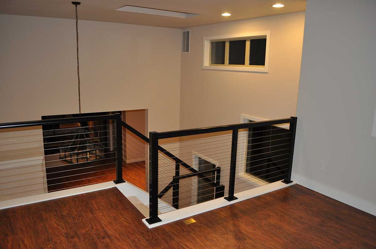 An empty room with a staircase and a window