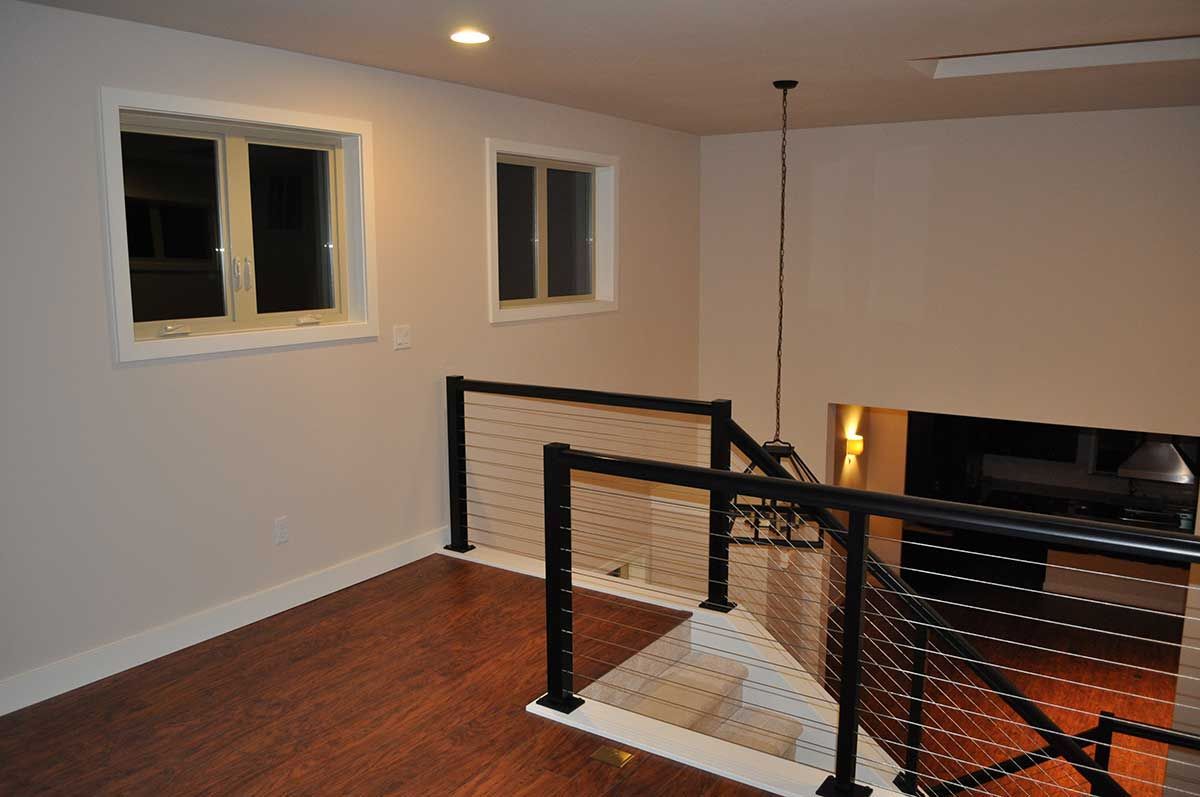 An empty room with stairs leading up to the second floor