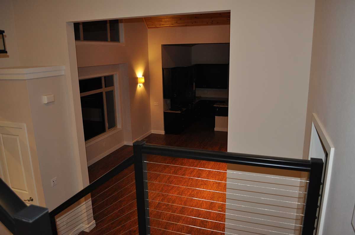 A view of a living room from the top of a staircase