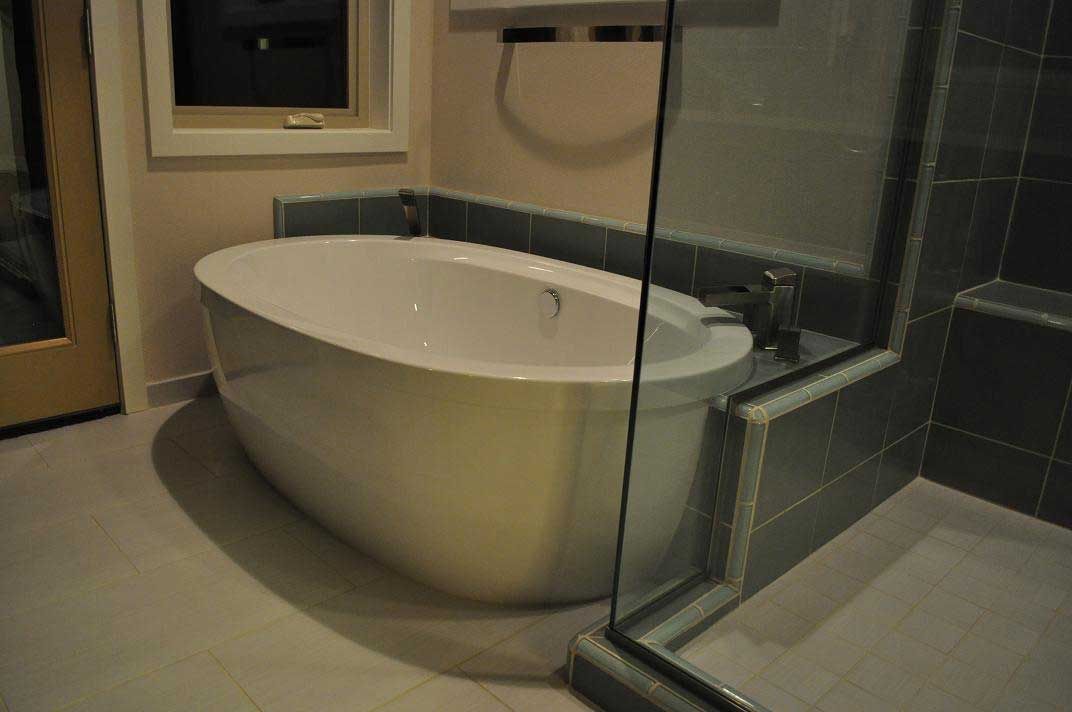 A bathroom with a bathtub and a walk in shower.