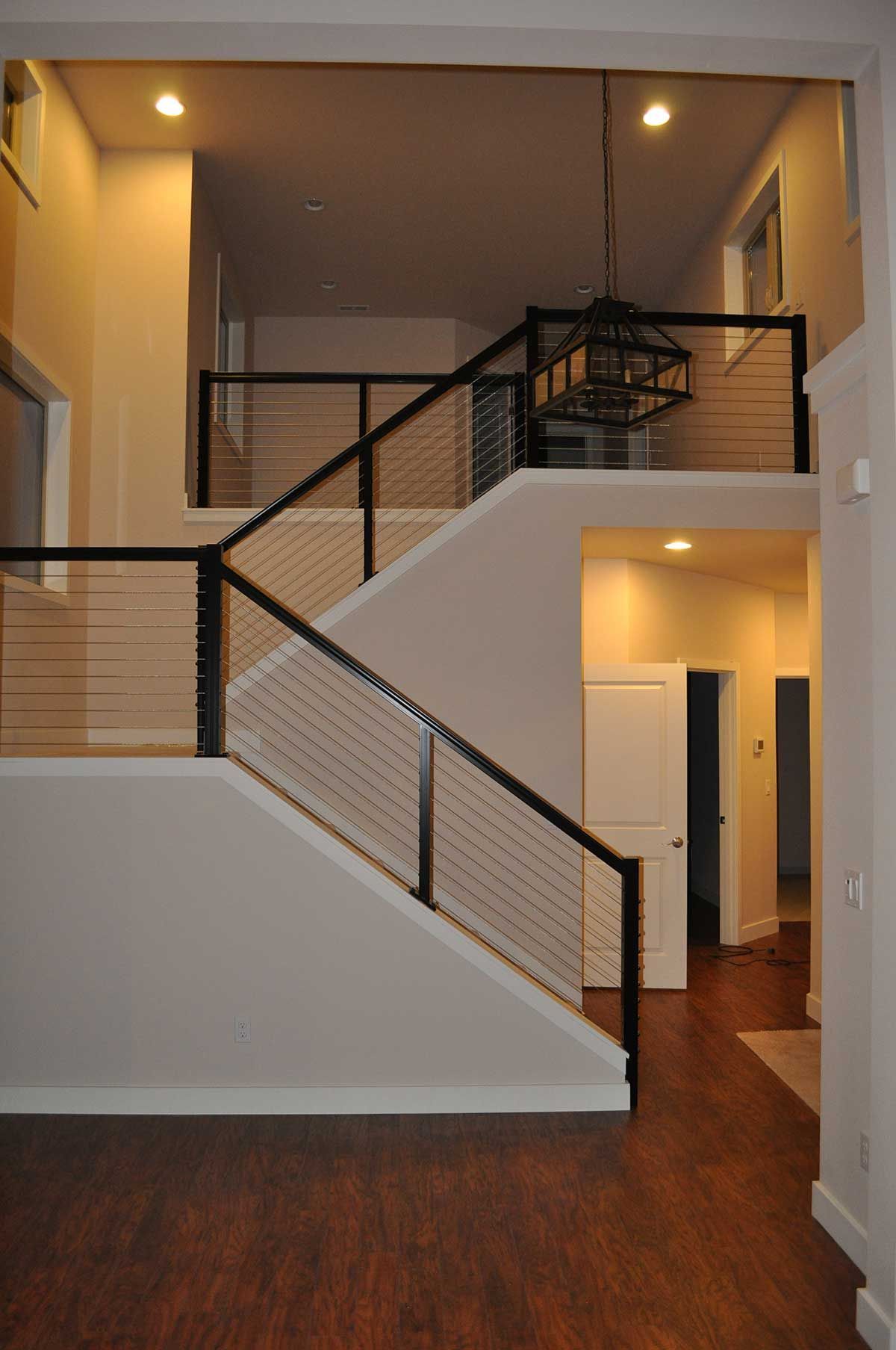 An empty house with stairs leading up to the second floor