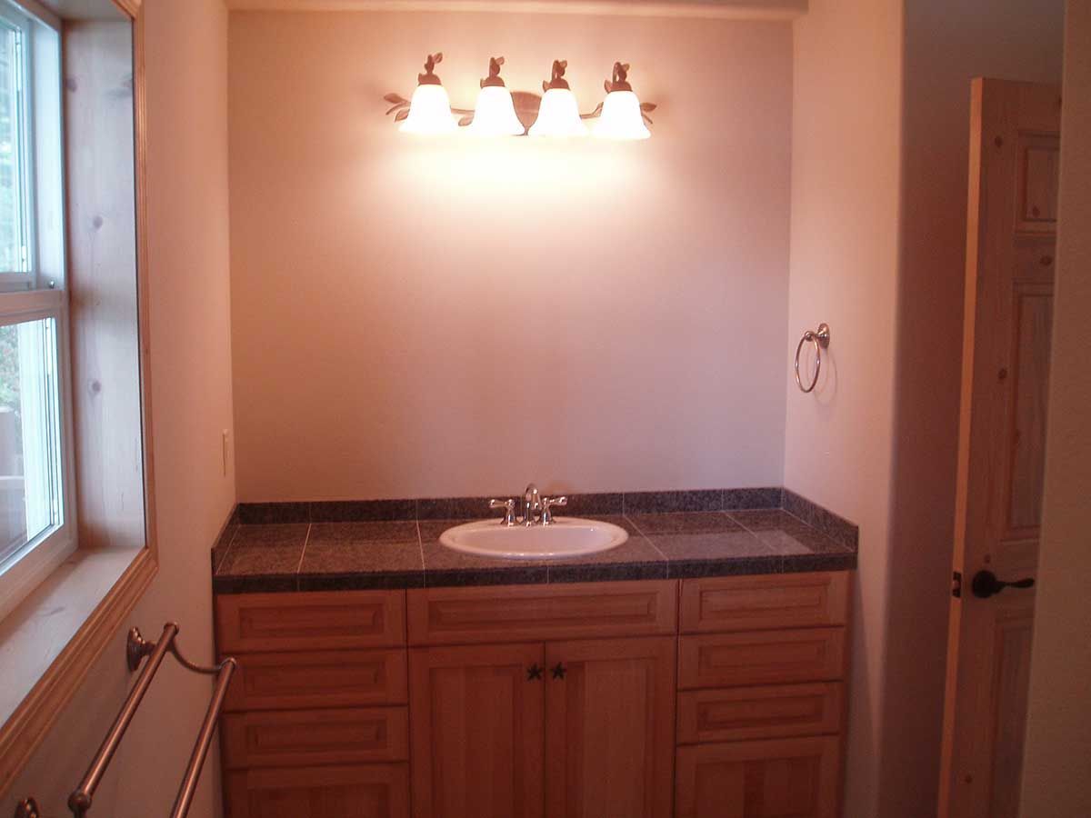 A bathroom with a sink and a window