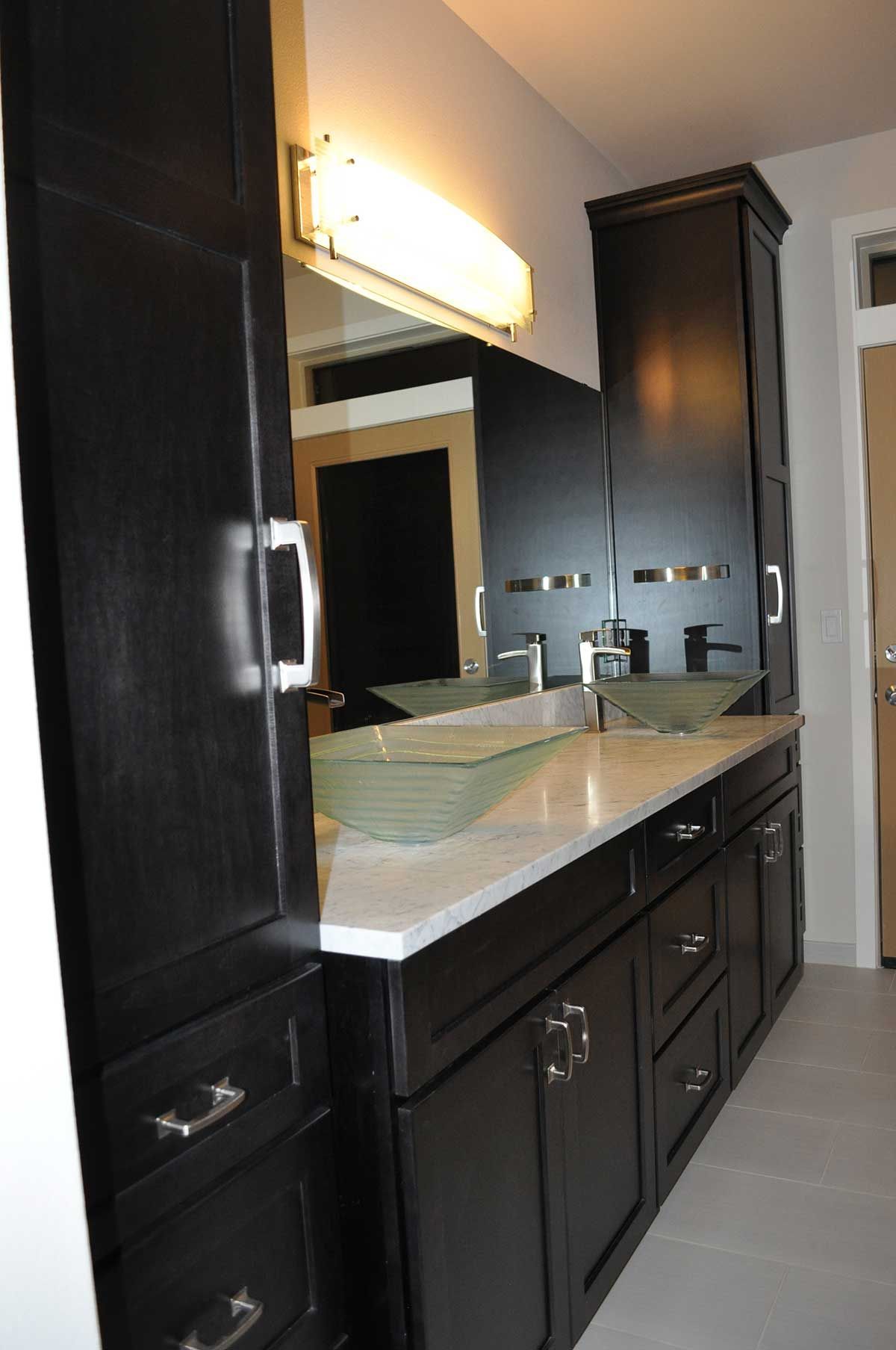 A bathroom with two sinks and a large mirror