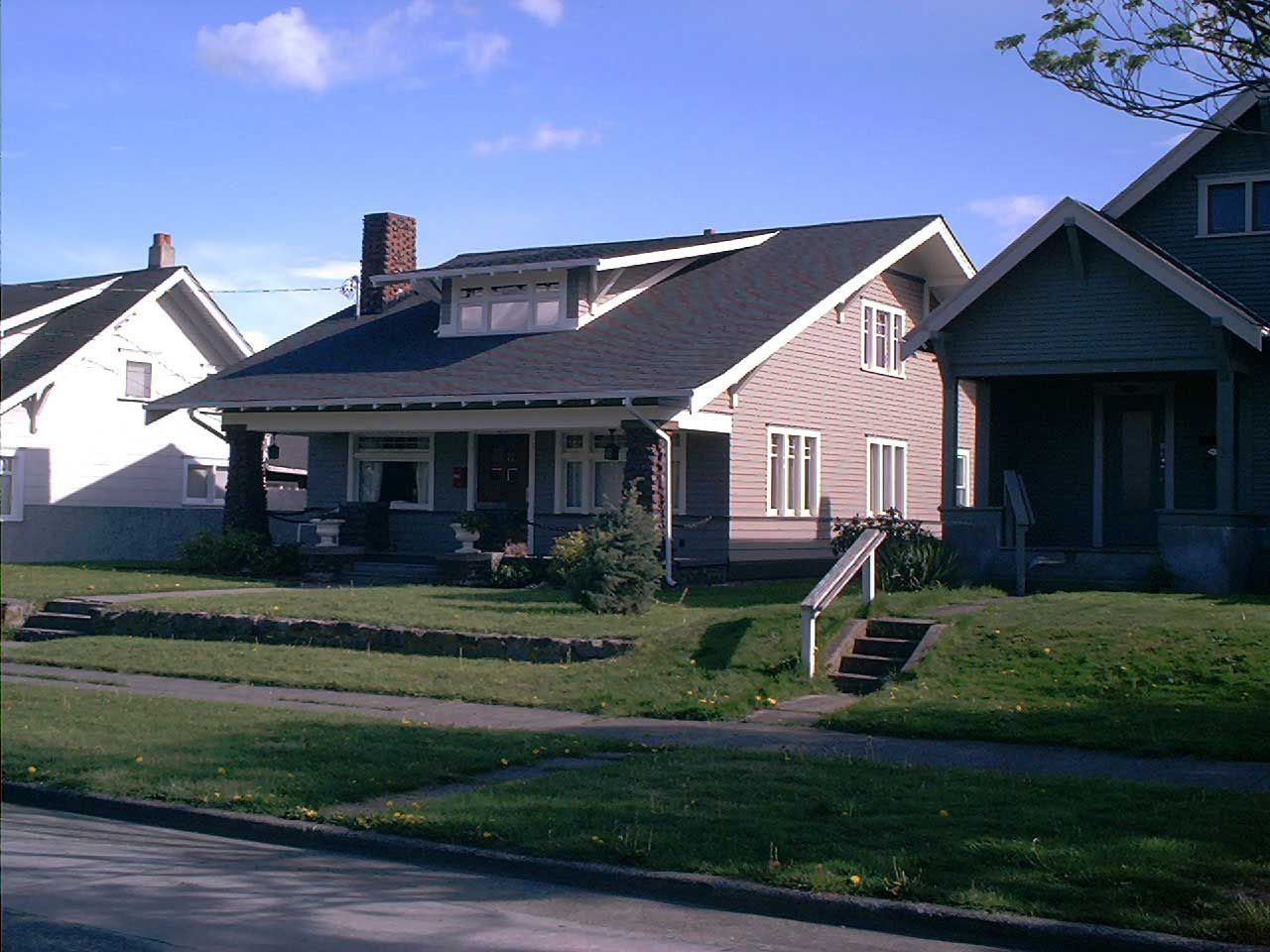 A row of houses are lined up on a sunny day