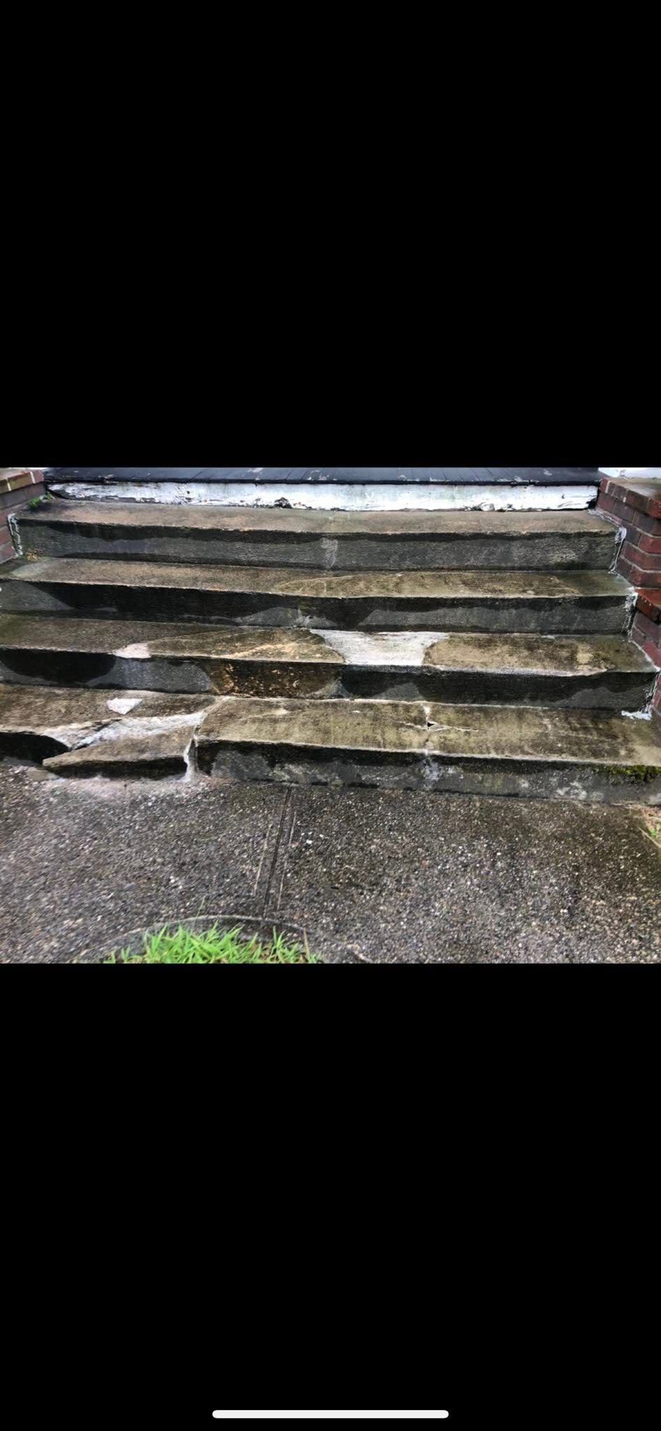 Concrete steps leading upwards; weathered and slightly mossy. Green grass at the base.