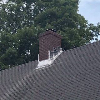 Chimney on an asphalt shingle roof