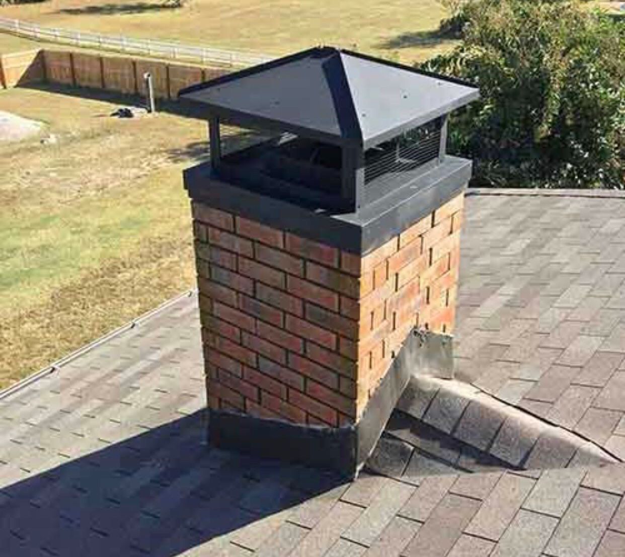 Brick chimney on an asphalt shingle roof