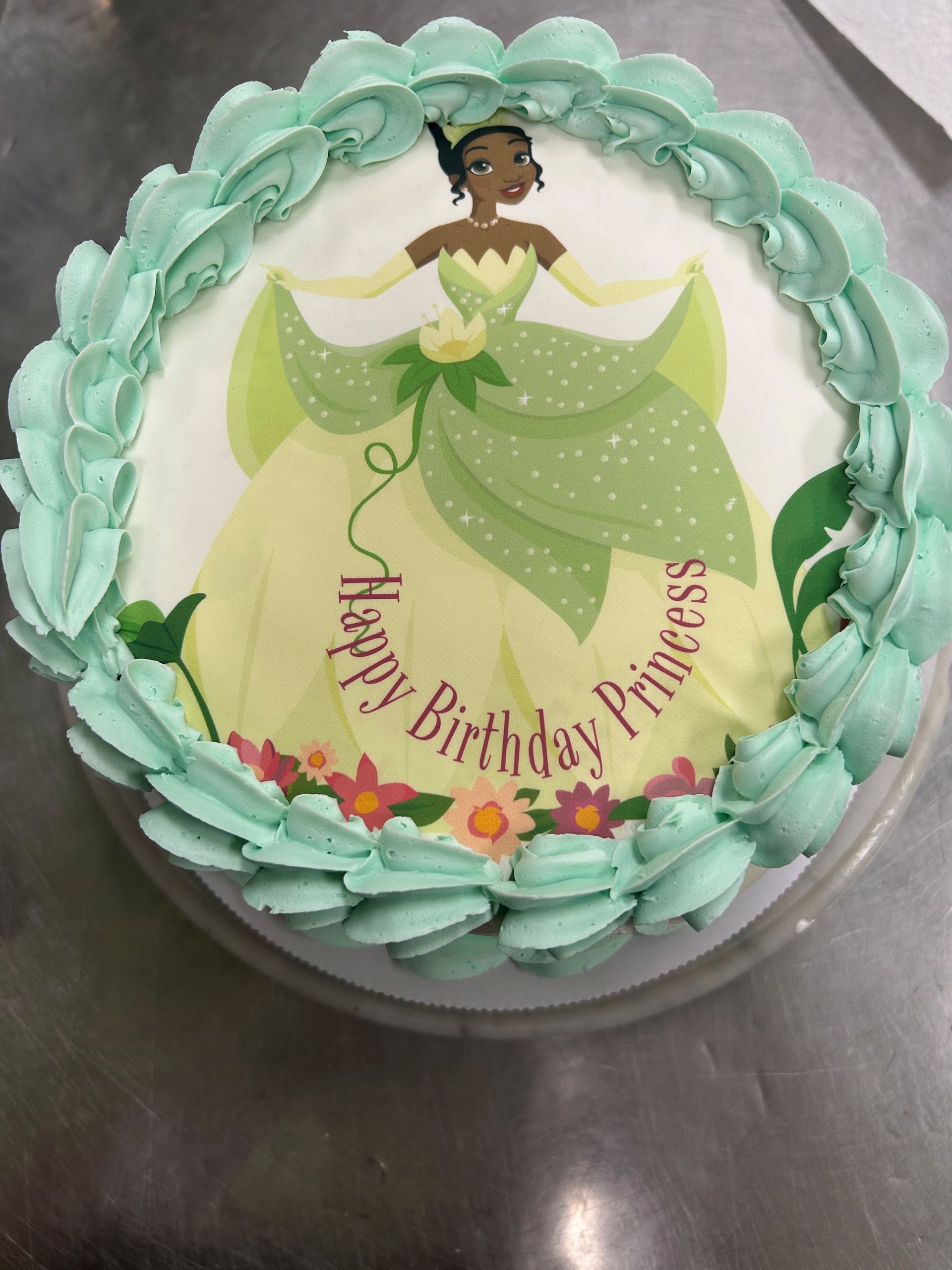 A birthday cake with a picture of a princess on it