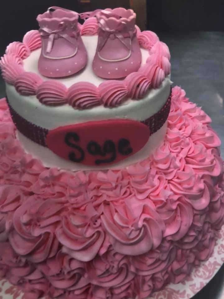A pink cake with the name sage on it